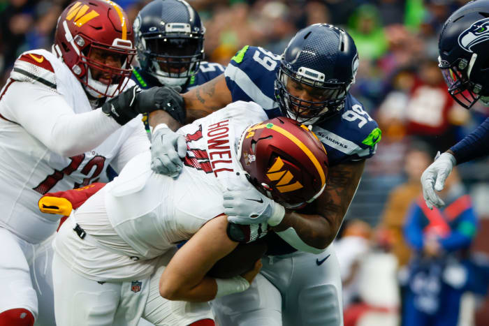 Seattle Seahawks defensive end Leonard Williams (99) sacks Washington Commanders quarterback Sam Howell (14) during the second quarter at Lumen Field.